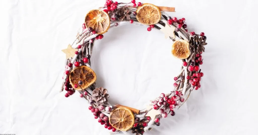Winter-inspired wreath with dried oranges, red berries, and pinecones - spring decor ideas for transitional seasonal styling